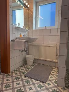 a bathroom with a sink and a mirror at Helle Ferienwohnung Saunahaus in Annaberg im Lammertal +38 photos