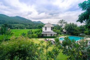 a resort with a swimming pool and a gazebo at Pai Vieng Fah Resort in Pai