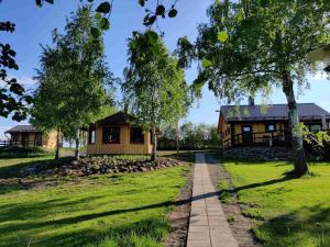 a house in a park with trees and a path at Kaijonselän mökit Kaita in Kaitainen