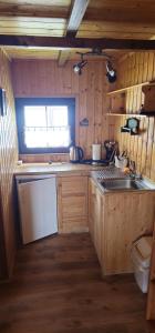 a small kitchen with a sink and a toilet at Rybacka chata in Rusinowo +7 photos