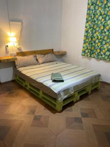 a bed in a bedroom with a lamp on a wall at Kowlessur Residence in Surinam