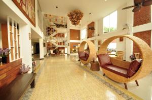 a living room with wicker chairs and a lobby at My Chiangmai Boutique Lodge in Chiang Mai