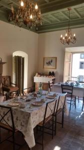 a dining room with a table and chairs and a chandelier at Clockwise in Viterbo