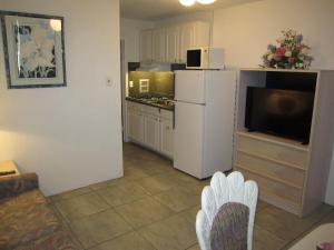 a kitchen with a white refrigerator and a tv at Apollo Motel in Wildwood Crest