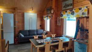 a living room with a couch and a table at Kaijonselän mökit Kaita in Kaitainen
