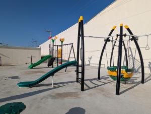 an empty playground with slides and swings at Relaxing Pool-View Studio in Mactan with Balcony in Lapu Lapu City