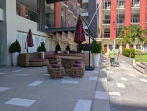 a man walking down a sidewalk in front of a building at Relaxing Pool-View Studio in Mactan with Balcony in Lapu Lapu City