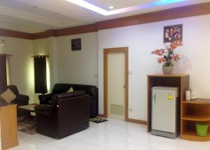 a living room with a couch and a refrigerator at Parada Place in Khon Kaen