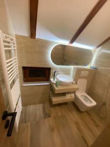 a small bathroom with a sink and a toilet at Planinska kuća Aurahill-Blidinje in Blidinje +32 photos