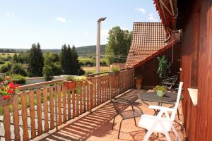 a patio with a table and chairs on a deck at Pension La Cascina in Tuttlingen