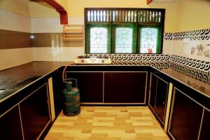 a kitchen with a counter and a window in it at Jaffna Bungalow in Jaffna