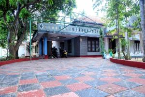 a building with a courtyard in front of it at Jaffna Bungalow in Jaffna