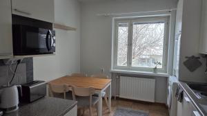 a small kitchen with a table and a window at Kaksio Kimpisessä in Lappeenranta