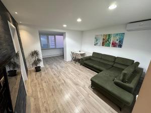a living room with a couch and a table at Apartment City Center in Piteşti