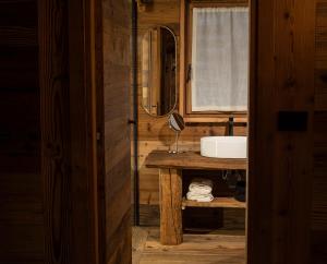 a bathroom with a sink and a mirror at Alpine Majestic Rascard - Unique Mountain Experience with Balcony and panoramic views in Champoluc
