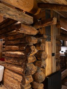 a wall of logs in a log cabin at Alpine Majestic Rascard - Unique Mountain Experience with Balcony and panoramic views in Champoluc
