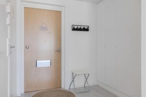 a door in a room with a stool next to it at QnQ studio apartment in Helsinki