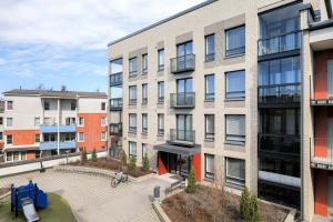 an apartment building with a courtyard in front of it at QnQ studio apartment in Helsinki