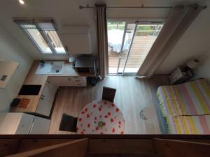 an overhead view of a room with a bedroom and a bed at Entre Terre et Camargue- Studio de Charme in Le Cailar