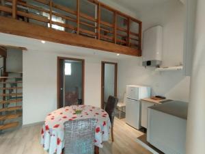 a dining room with a table and a kitchen at Entre Terre et Camargue- Studio de Charme in Le Cailar