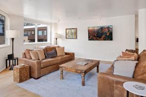 a living room with a couch and a table at Ice House 317 condo in Telluride +40 photos
