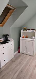 a room with a white dresser in a attic at La Re Source Chambres et table d'hôtes in Villers-le-Lac