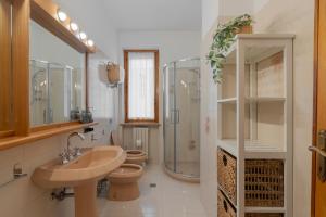 a bathroom with two toilets and a sink and a shower at Villa Pia in Bevagna +21 photos
