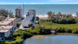 an aerial view of a beach and buildings and a body of water at Beach Access & Heated Pool Resort Condo for 8 in Clearwater Beach