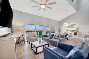 a living room with a couch and a table at Beach Access & Heated Pool Resort Condo for 8 in Clearwater Beach +15 photos