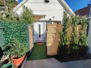 a garden with a gate and plants in front of a house at Ella1 in Sremska Kamenica