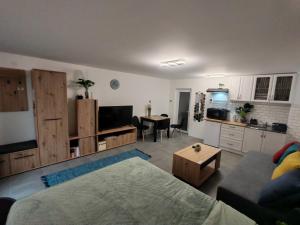 a living room with a couch and a table at Ella1 in Sremska Kamenica