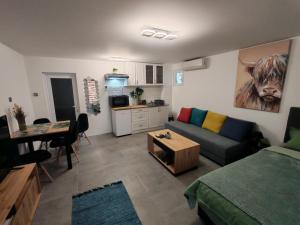 a living room with a couch and a table at Ella1 in Sremska Kamenica