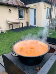 a pot of soup on a grill with smoke at Casa JOY in Râşnov