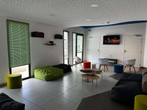 a living room with a couch and a table at Ibis Styles Collioure Port Vendres in Port-Vendres