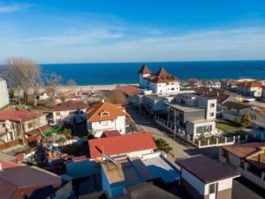 an aerial view of a town with houses and the ocean at Tropical Beach in Eforie Sud