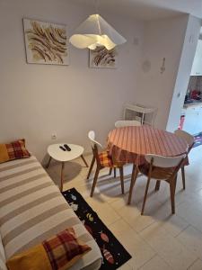 a living room with a table and a dining room at Vacation home Dora in Baška