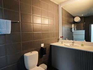 a bathroom with a toilet and a sink and a mirror at St. Lazaros Studios in Larnaca +61 photos