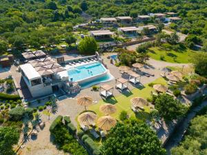 an aerial view of a resort with a swimming pool and umbrellas at Holiday Homes Kanajt in Punat