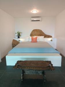 a bedroom with a bed with a blue comforter at Spacious & Scenic View with Swimming Pool Aza Sunset Villa 2 in Langkawi Intl