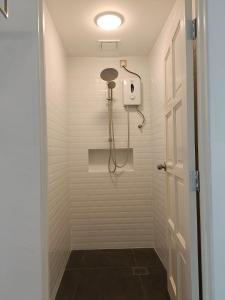 a shower with a shower head in a bathroom at Spacious & Scenic View with Swimming Pool Aza Sunset Villa 2 in Langkawi Intl +24 photos