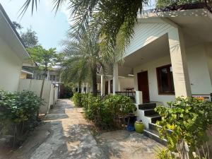 a house with a palm tree in front of it at Diamond Beach Resort in Ko Samed