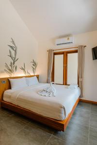 a bedroom with a large bed with white sheets at Diamond Beach Resort in Ko Samed +195 photos