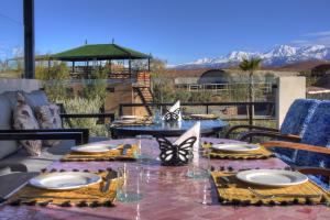 a table with plates and napkins on a patio at The Ranch Camp in El Karia
