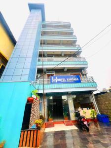 a building with a motorcycle parked in front of it at Hotel Kandara in Pokhara