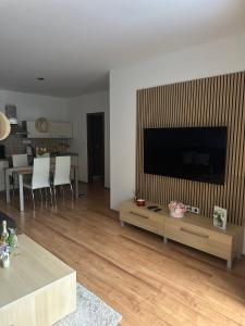 a living room with a large flat screen tv at Apartmán Emy in Bystrá
