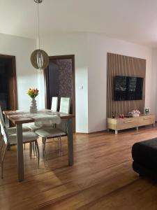 a living room with a dining room table and chairs at Apartmán Emy in Bystrá