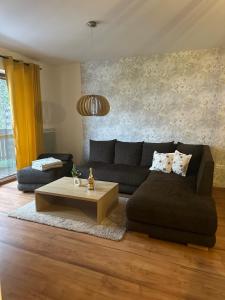 a living room with a couch and a coffee table at Apartmán Emy in Bystrá