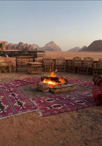 a fire pit in the middle of the desert at Sunrise Magic Camp in Wadi Rum