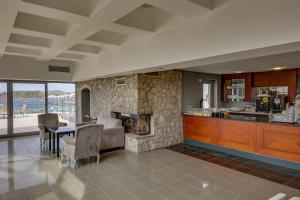 a kitchen and living room with a stone fireplace at Diamond Of Bodrum in Bodrum City