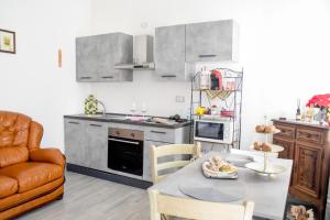 a small kitchen with a table and a couch at Profumo di Vigna - Roero in Occhetti